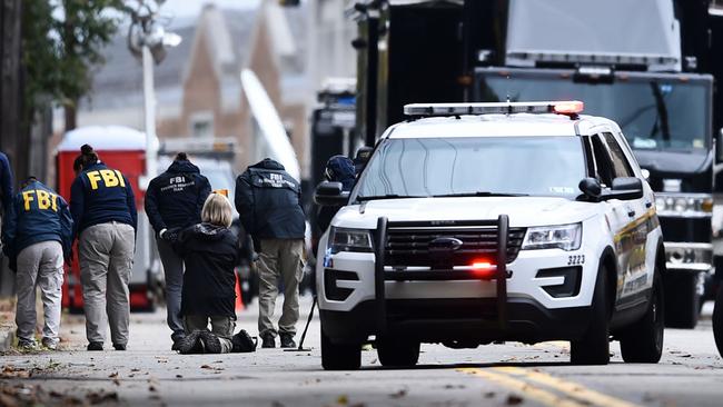 The FBI searches for clues outside the Tree of Life Synagogue in Pittsburgh yesterday. Picture: AFP