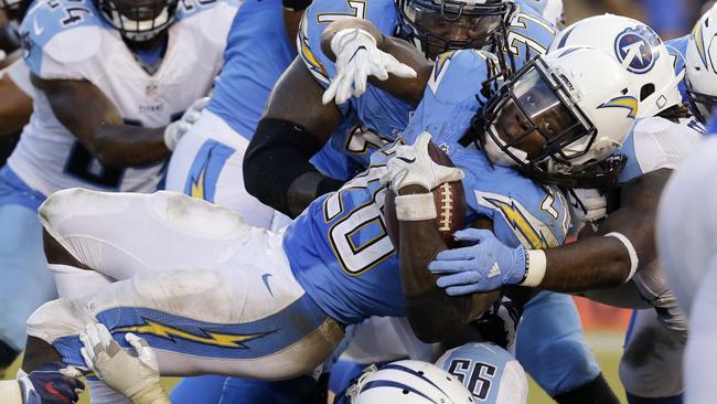 San Diego Chargers running back Melvin Gordon, center, is upended.