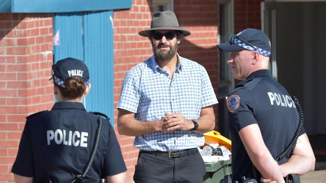 Crown prosecutor Lloyd Babb SC with police officers outside the Palms Motel during tour of the scene for jurors on Thursday.