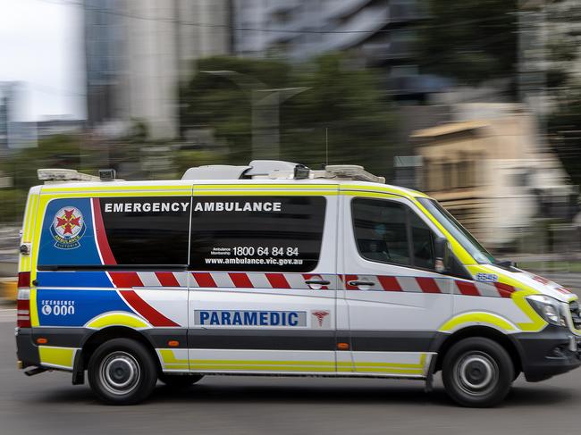 MELBOURNE, AUSTRALIA - NewsWire Photos FEBRUARY 13, 2022: An ambulance speeds away from the Royal Melbourne Hospital. Ambulance, Generic.Picture: NCA NewsWire / David Geraghty