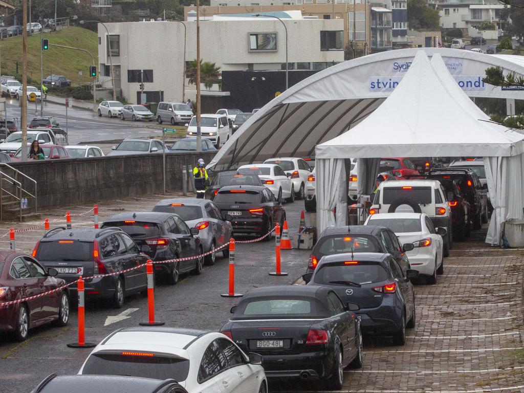 Cars wait in line at a Bondi Beach COVID-19 drive-through testing clinic. Picture: Jenny Evans/Getty Images