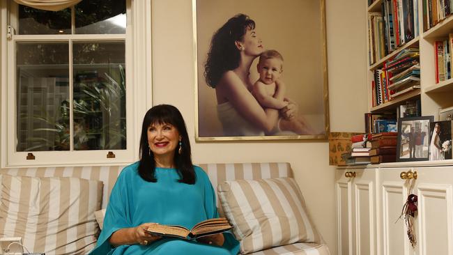 Alexandra Joel at her Double Bay home in front of an Anthony Buckley and Constantine photo portrait of her and son Bennett. Picture: John Appleyard