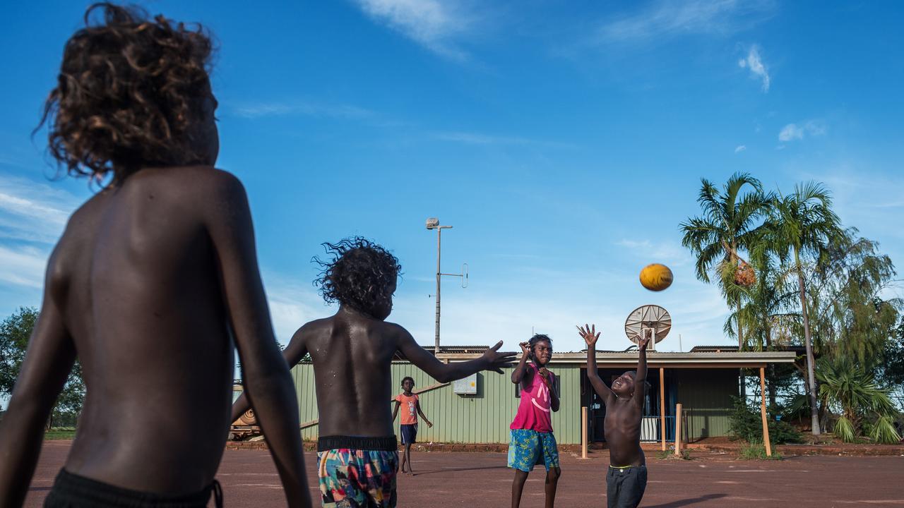 Children play football in Maningrida, a remote Aboriginal community in Arnhem Land. Picture: Jake Nowakowski