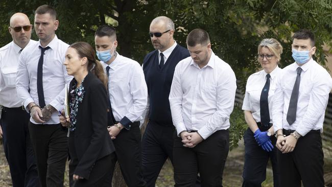 Left-to-right, in handcuffs: Thomas Nichols, Thomas Pinnington, Jeremy Dale Sandell and Kain Mazomenos at Adelaide High School. Picture: NCA NewsWire