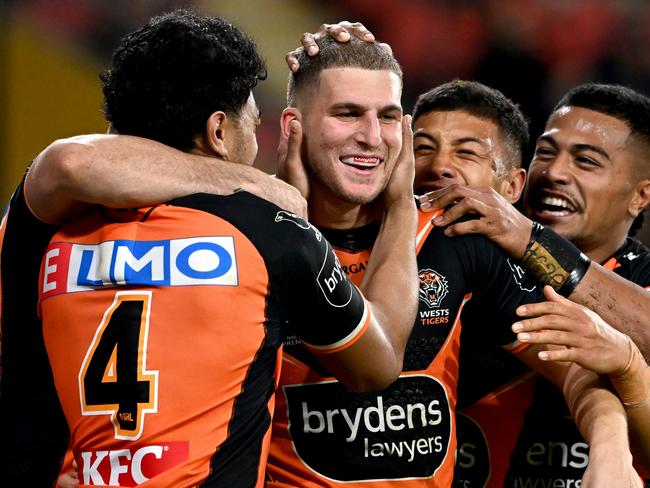 BRISBANE, AUSTRALIA - JULY 30: Adam Doueihi of the Tigers is congratulated by team mates after scoring a try during the round 20 NRL match between the Brisbane Broncos and the Wests Tigers at Suncorp Stadium, on July 30, 2022, in Brisbane, Australia. (Photo by Bradley Kanaris/Getty Images)