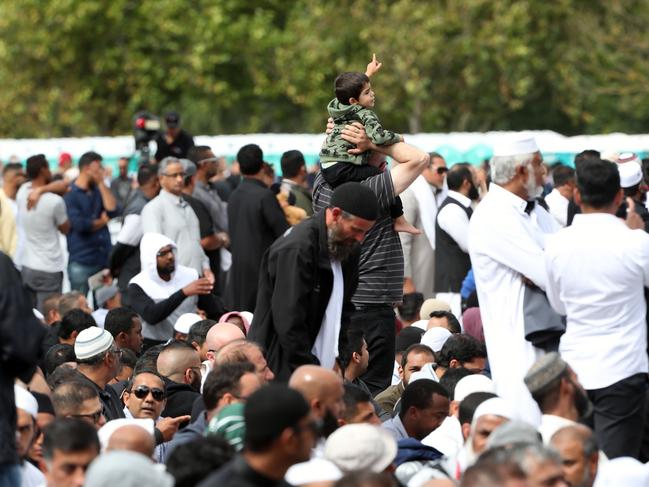 A small boy on his fathers shoulder's at a mass Friday prayer opposite the Al Noor Mosque, in Christchurch. This was New Zealand worst ever mass shooting event. Picture Gary Ramage