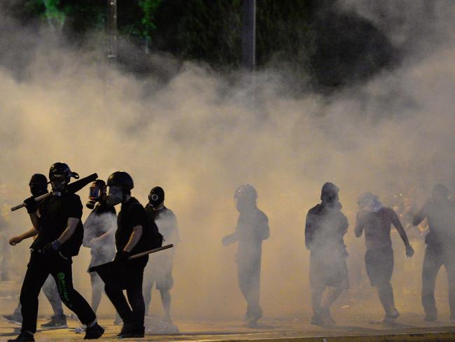 Protesters clash with riot police in front of the Greek Parliament<b>.</b>