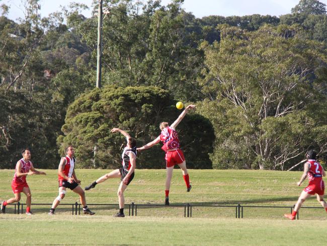 FLYING HIGH: Lismore Swans player soard above Sawtell Toormina Devils during the Sir Doug Nicholls Round on May 29, 2021. Photo: Alison Paterson