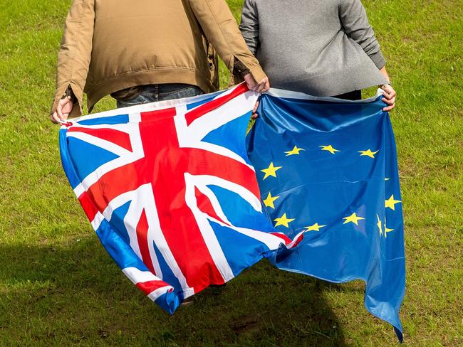 People display United Kingdom and Europe's flags on June 24, 2016 in Neufchâtel-Hardelot. Brexit campaigner Michael Gove announced a surprise bid Thursday to become Britain's next prime minister, in a blow for his close ally Boris Johnson's chances, as turmoil gripped both the country's main political parties after the shock vote to leave the EU. / AFP PHOTO / PHILIPPE HUGUEN