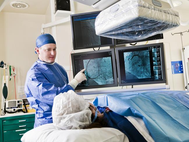 Cathlab in modern hospital with doctor and patient