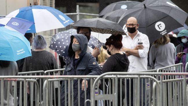 Melburnians queue in the rain at The Alfred hospital for coronavirus testing on Sunday morning. Picture: NCA NewsWire / David Geraghty