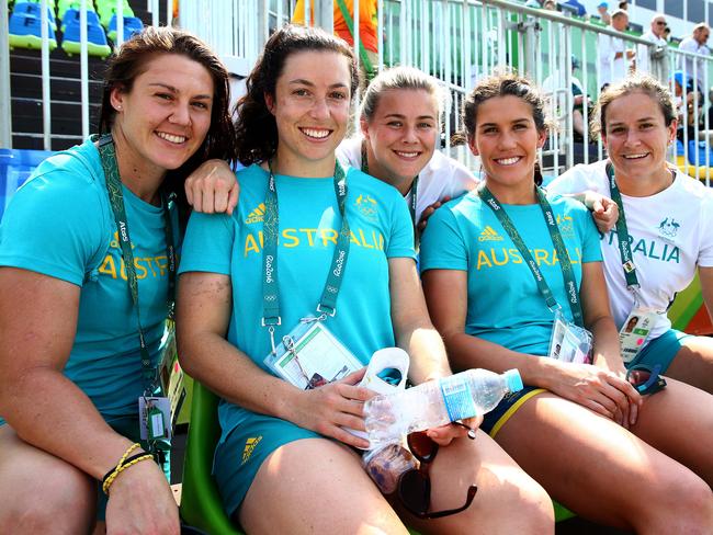 Australian women's sevens gold medallists Sharni Williams, Emilee Cherry, Nicole Beck, Charlotte Caslick and Shannon Parry support the mens team during the 2016 Rio Olympic Men's Rugby Sevens game between Australia and France at Deodoro Stadium, Rio. Pics Adam Head