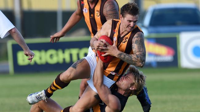 Hackham’s Brett Challis is tackled in an SFL game in 2016 by Brighton’s James Wray. The Hawks have registered interest in joining the Adelaide Footy League. Picture: Tom Huntley