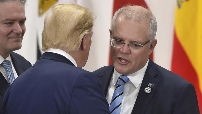 Prime Minister Scott Morrison, right, chats with US President Donald Trump, centre, watched on by Mathias Cormann at the G-20 summit in Osaka in June.