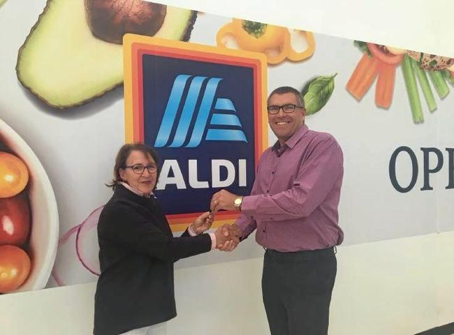 DC8 Director (Aldi's architecture firm) Marianne McKenzie, hands over the keys for  the new store to Tweed Mall manager John Weaver. Picture: Supplied