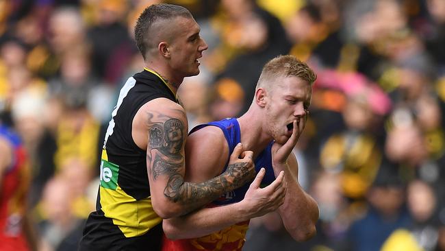 ‘Elite’ Richmond midfielder Dustin Martin gets some attention from Brisbane tagger Nick Robertson on Sunday. Picture: AAP Image/Julian Smith