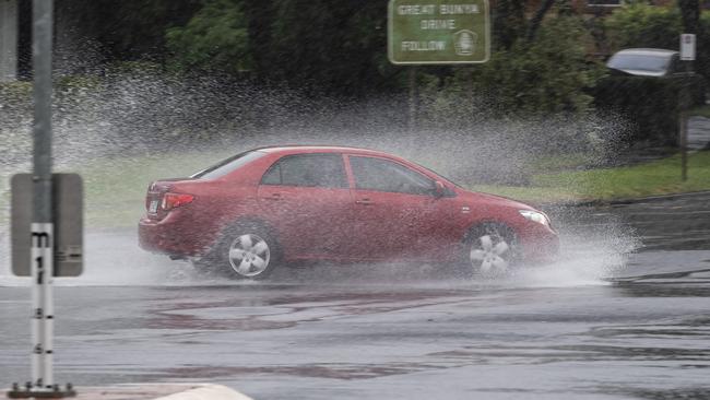 Traffic at the intersection of James and Kitchen Sts as rain continues to fall in Toowoomba in the aftermath of TC Alfred, Sunday, March 9, 2025. Picture: Kevin Farmer