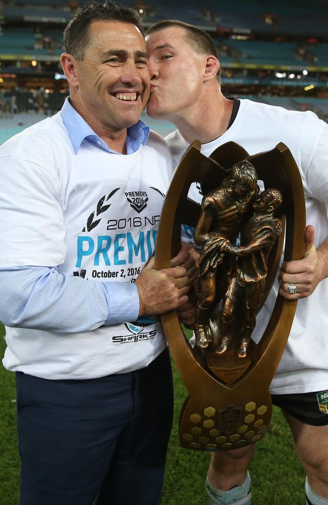 Gallen holding the Premiership trophy plants a smacker on coach Shane Flanagan. Picture: AAP Image/Craig Golding