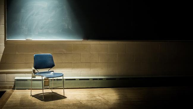 An Empty Chair in a Dark Classroom. Generic classroom, empty classroom, teaching, student, school. Picture: iStock