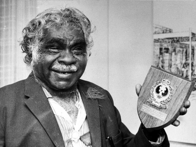 Aboriginal tracker Jimmy James holding plaque presented to him by police on his 75th birthday.