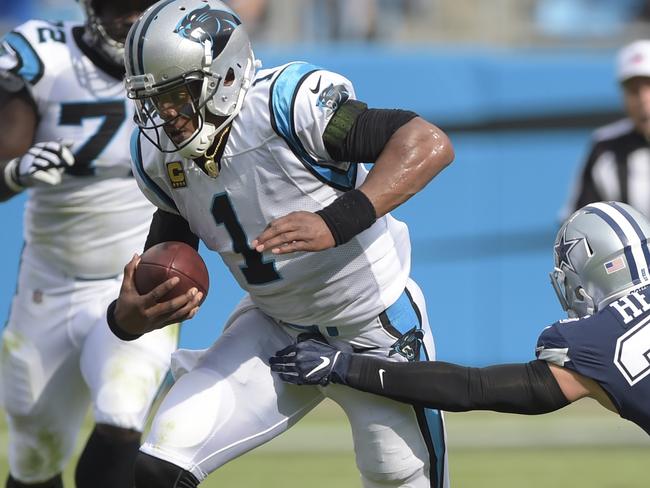 Carolina Panthers' Cam Newton (1) runs past Dallas Cowboys' Jeff Heath