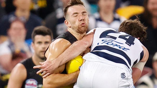 First-time premiership player Noah Balta absorbs a big hit from Jed Bews.