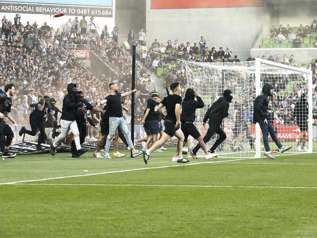 MELBOURNE, AUSTRALIA - DECEMBER 17: Fans storm the pitch in protest during the round eight A-League Men's match between Melbourne City and Melbourne Victory at AAMI Park, on December 17, 2022, in Melbourne, Australia. (Photo by Darrian Traynor/Getty Images)