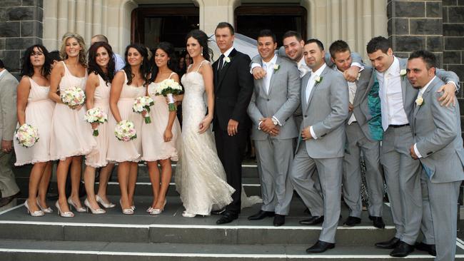 The glamorous wedding party pose for a snap.