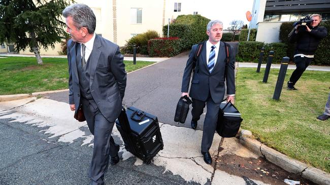 Federal police officers leaving the home of News Corp National Political Editor Annika Smethurst on Tuesday.