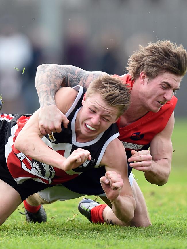 Mt Eliza's Brodie Shaw tackles a Bonbeach opponent.