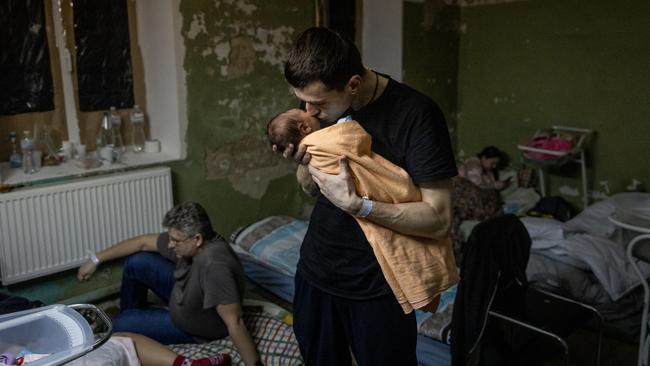 A man holds a newborn child in the bomb shelter of a maternity hospital in Kyiv, Ukraine. Picture: Chris McGrath/Getty Images