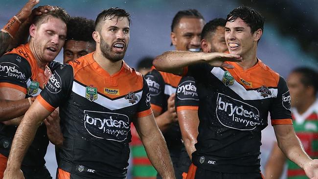 Tigers celebrates scoring a try with Wests Tigers team mates.