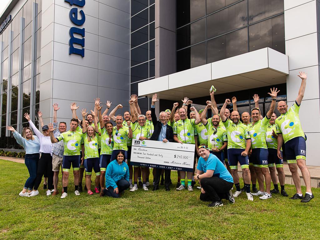 Ms Mishra, pictured front left, in blue, accepted a $240,000 donation for cancer charity Canteen.