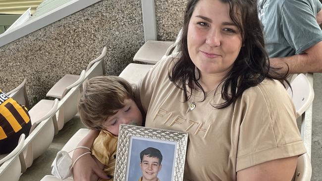 Georgie Gardam at an AFL tribute match with a photo of her son Zane who tragically died during a jumping castle accident at Hillcrest Primary School. Picture: Helen Kempton.