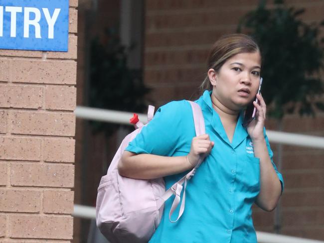 A worker outside the Dorothy Henderson Lodge at Macquarie Park. Picture: John Grainger