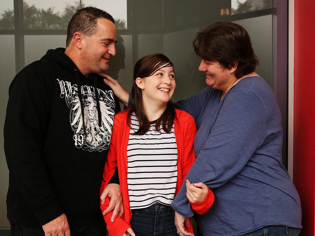 “Sophie” (not real name) chats with her parents. She was helped by the program under threat.