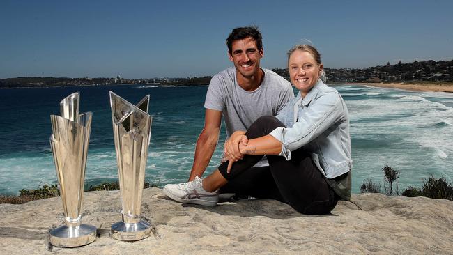 Australian cricketers Mitchell Starc and Alyssa Healy with the Women’s and Men’s ICC T20 World Cup trophies. Picture. Phil Hillyard