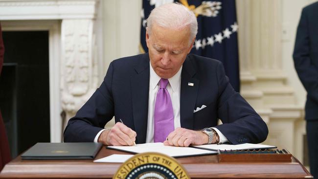 US President Joe Biden signs executive orders as part of the Covid-19 response in the State Dining Room of the White House in Washington. Picture: AFP