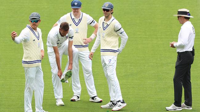 Trent Copeland checks his injured foot before leaving the MCG for scans. (Photo by Robert Cianflone/Getty Images)