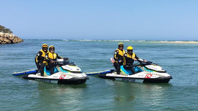 Nambucca Marine Rescue members head out on jetskis to rescue a couple whose boat overturned in the Nambucca River