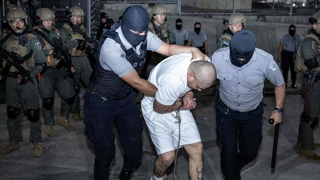 One of the prisoners is taken to a jail by authorities in El Salvador. Picture: El Salvador’s Presidency Press Office/AFP