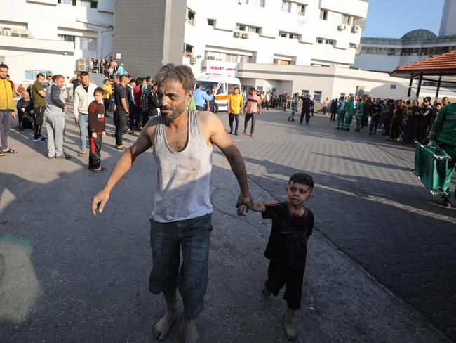 An injured Palestinian man and boy arrive to Al-Shifa hospital in Gaza City following Israeli bombardment. Picture: AFP