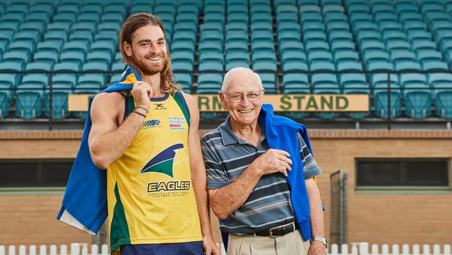 Fourth-generation Eagle Jordan Foote with his grandfather, John Foote, after signing with Woodville-West Torrens. Picture: Matt Loxton