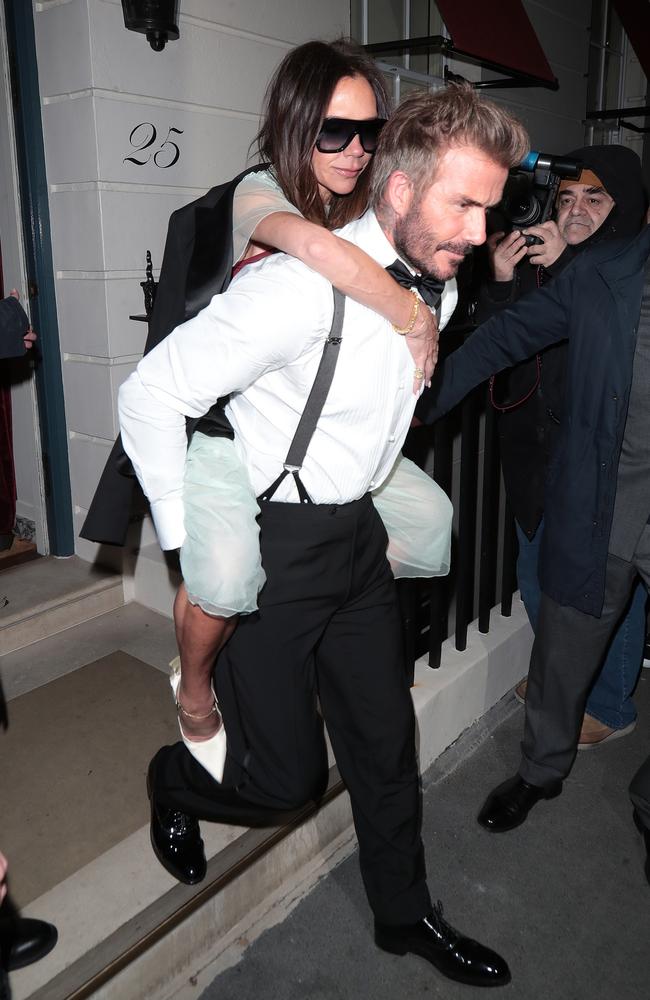 Mode of transport! Victoria Beckham and David Beckham exit her 50th birthday party in London. Picture: GC Images