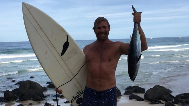 Nicholas Smith caught a Tuna in the ocean while surfing and had to fight off dolphins to keep it, he then went home and ate it.