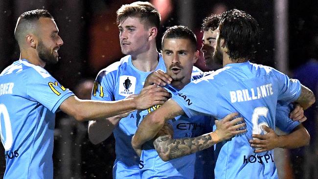 Melbourne City players congratulate striker Jamie Maclaren (centre) after he scored against Brisbane Strikers on Tuesday night. Picture: Getty Images