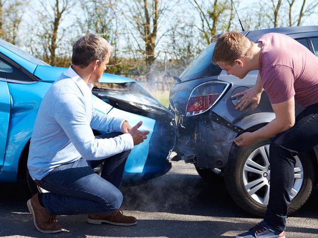 Two Drivers Arguing After Traffic Accident looking at damage, car insurance generic