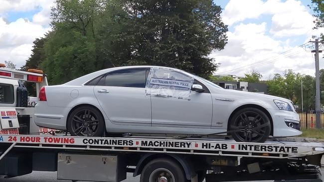 ACT police remove a bullet-riddled Holden Commodore from Manuka Oval in Canberra after forensic experts combed it for evidence following a shooting. Picture: Craig Dunlop