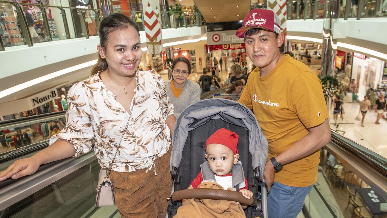 (from left) Mary, Jayden and Mark Cuenca checking out the bargains at Grand Central shopping centre. Friday, December 23, 2022. Picture: Nev Madsen.