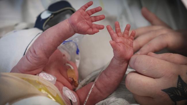 Mildura baby George Ford stretches his arms towards his mum Jasmin. Picture: David Caird